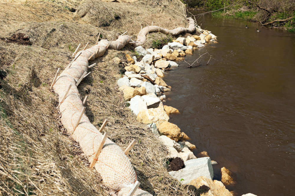 A river flows beside erosion control efforts in Nampa.